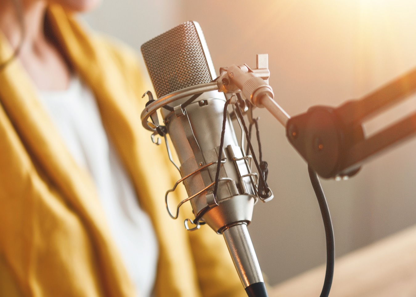 Person sitting in front of a microphone